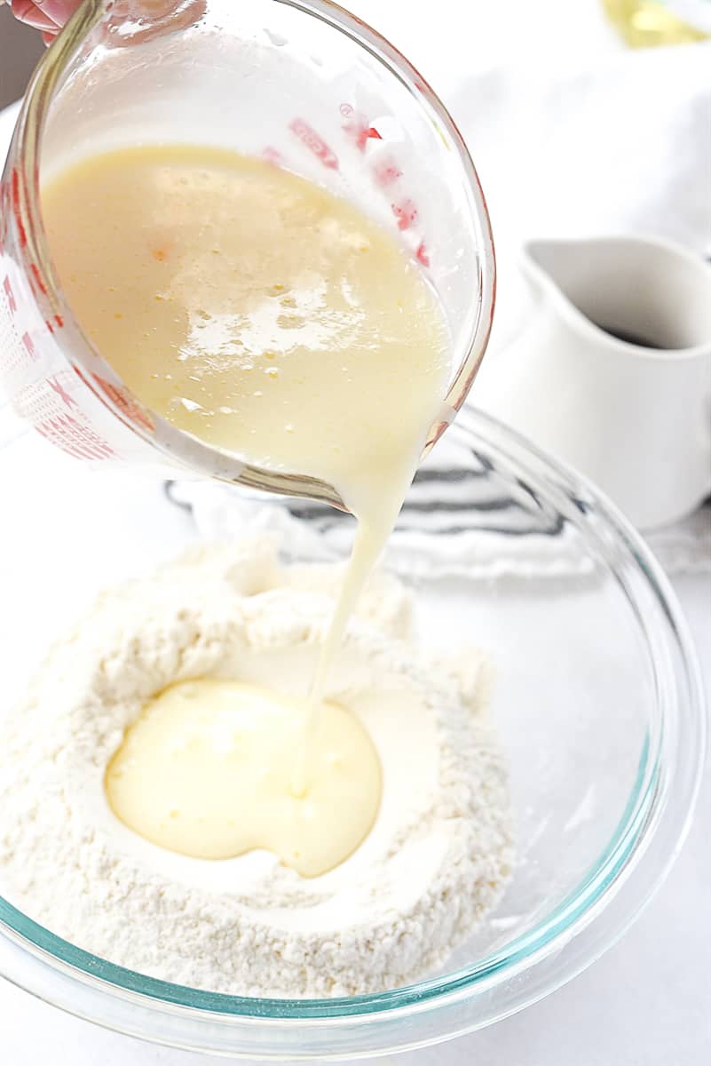 pouring wet ingredients into dry ingredients