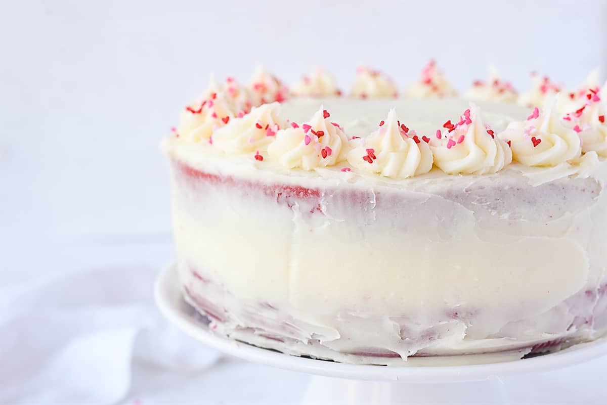 side view of a naked frosted red velvet cake