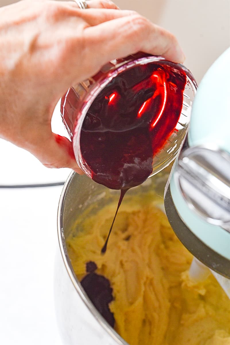 adding food color to red velvet cake