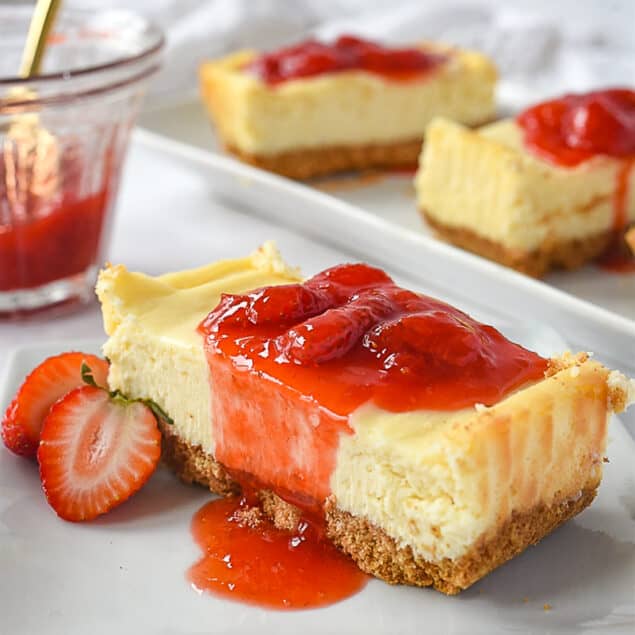 Slice of small batch cheesecake with strawberry sauce