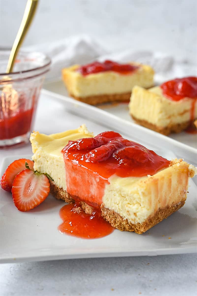 Slice of small batch cheesecake with strawberry sauce