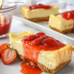 slice of small batch cheesecake with strawberry syrup on top