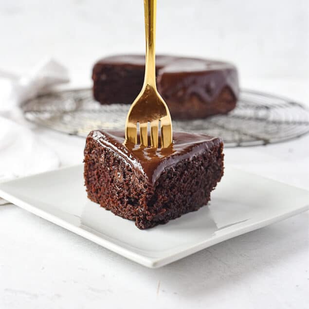 slice of chocolate cake with a fork in it.