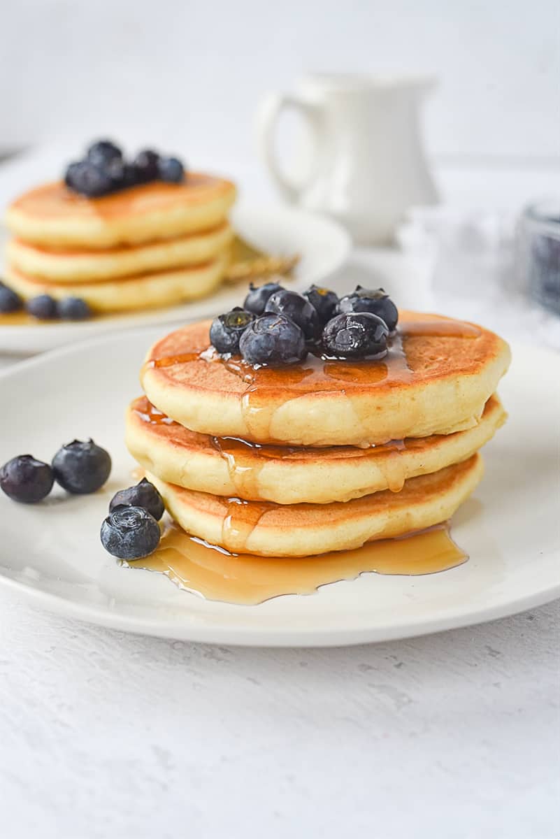 stack of three pancakes with blueberries on top