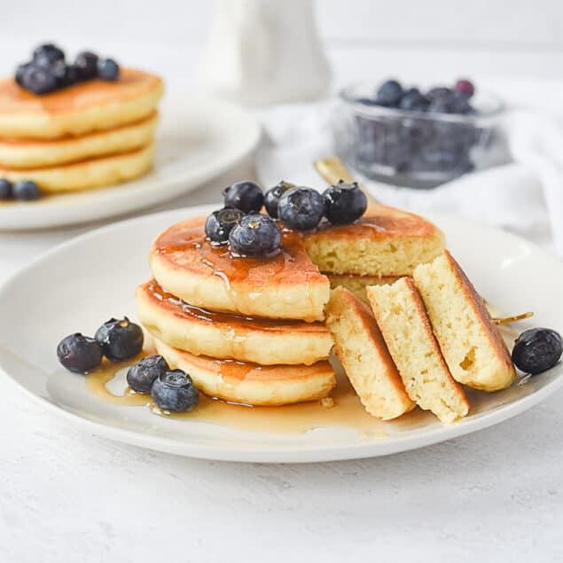 plate of 3 pancakes with blueberries