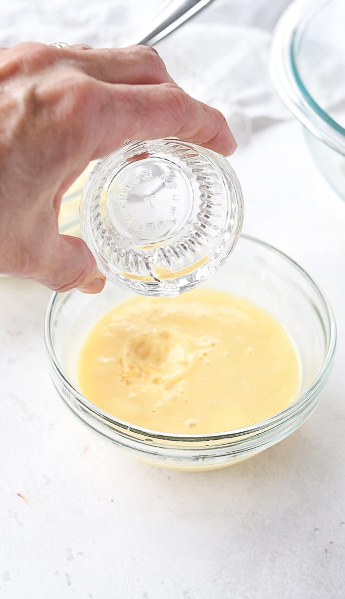 pouring vinegar into egg mixture