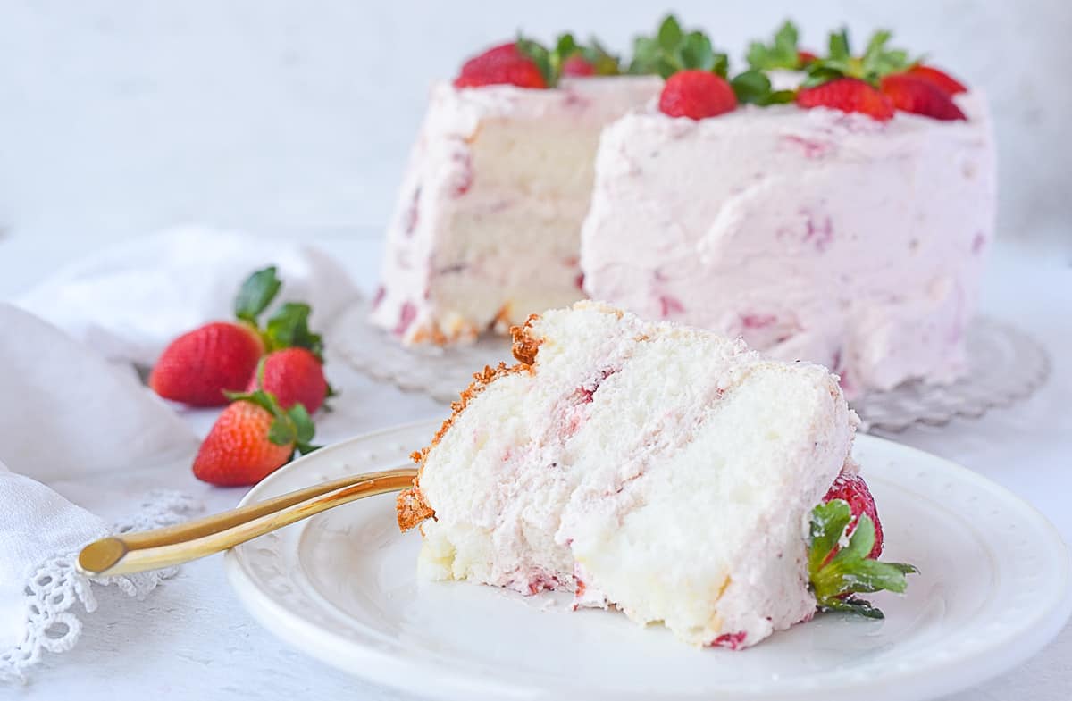 slice of strawberry cream cake on a plate