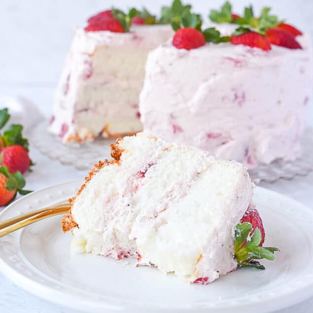 slice of strawberry cream cake on a plate