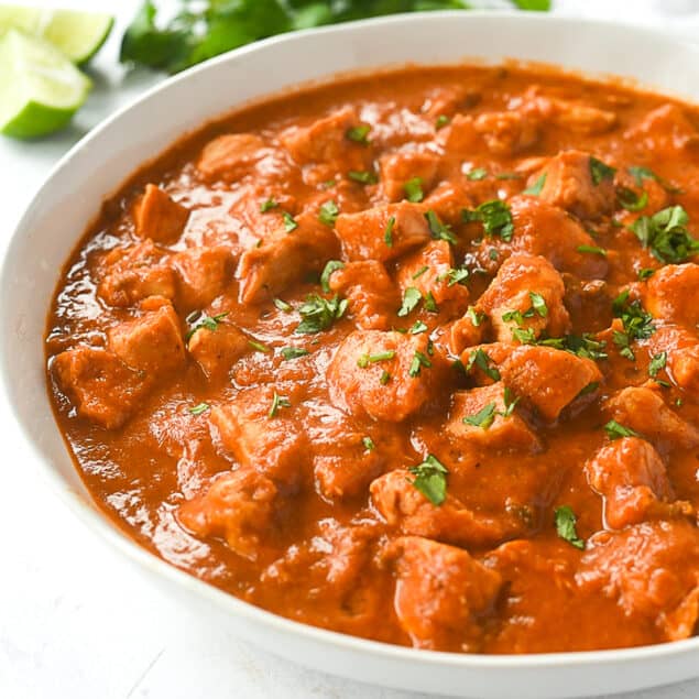 bowl of butter chicken with cilantro on top