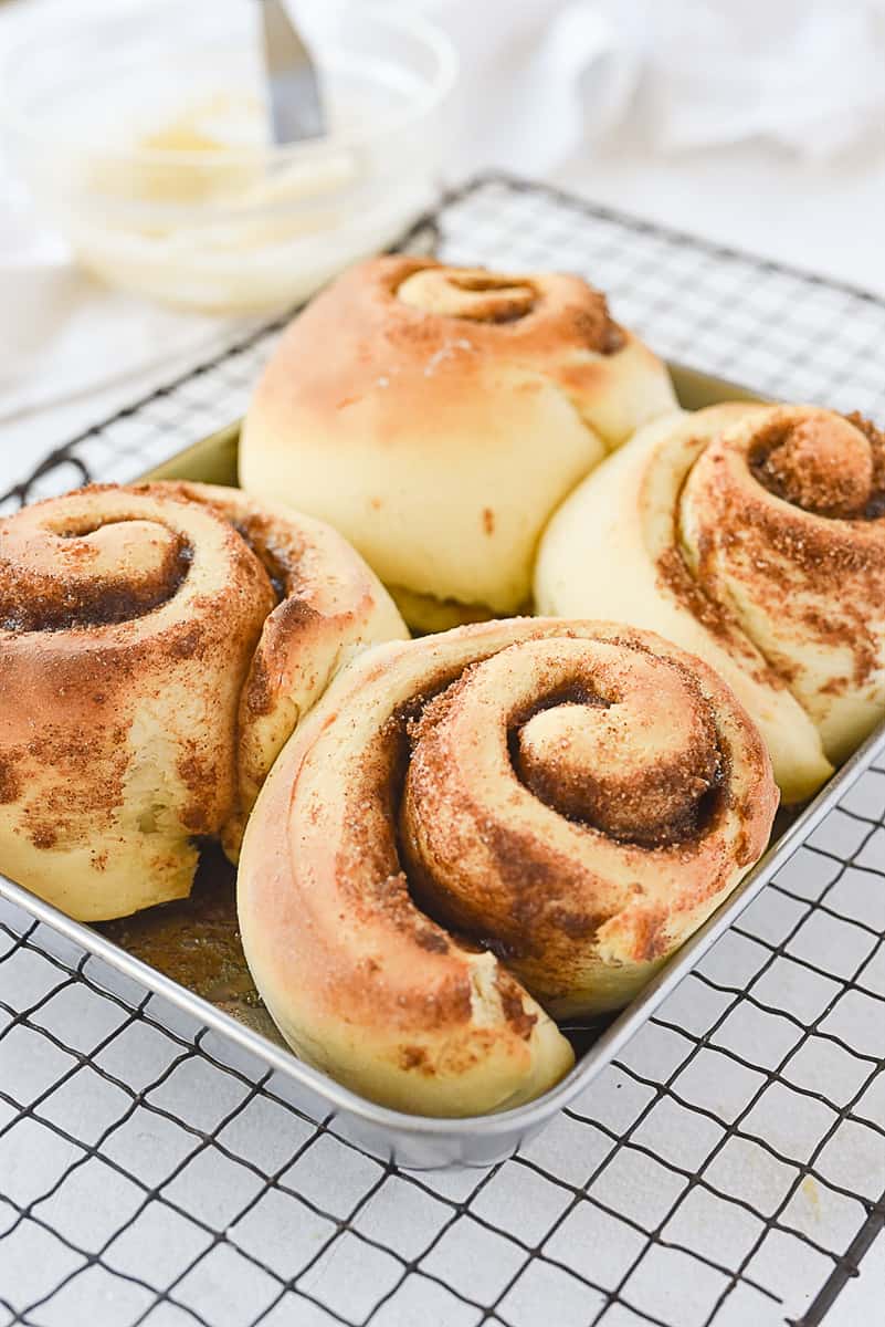 baked cinnamon rolls on a cooling rack