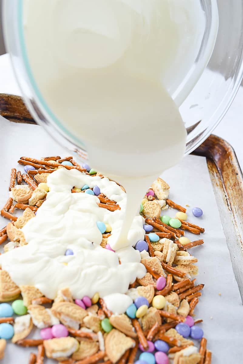 pouring chocolate over Easter Bark