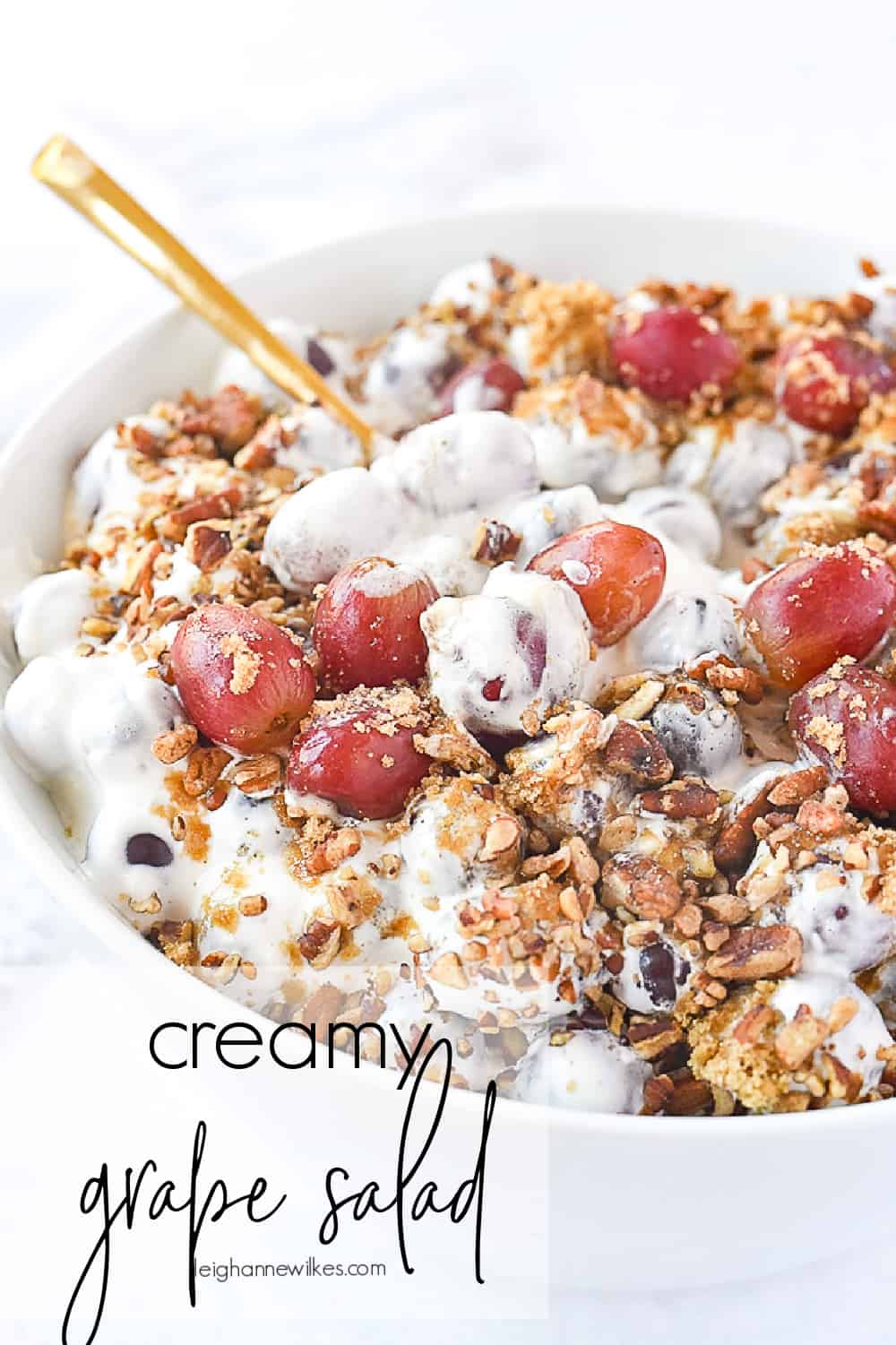 bowl of grape salad with a spoon in it