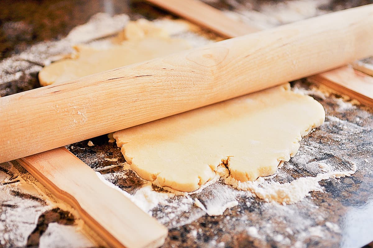 rollin out sugar cookie dough on counter