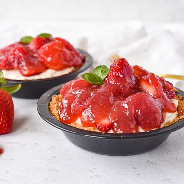 two mini strawberry pies in graham cracker crust