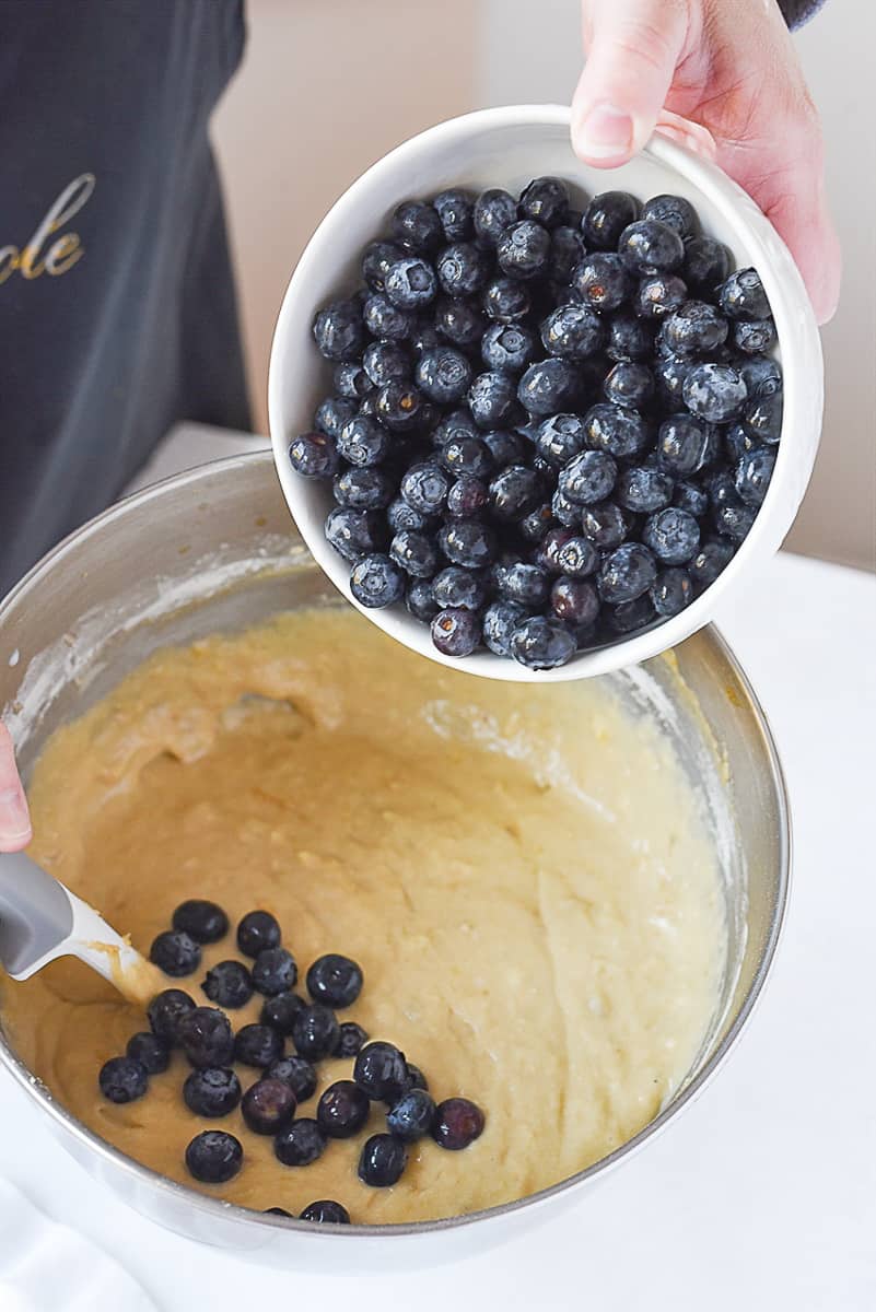 adding blueberries to cake batter