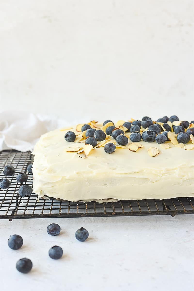 side view of blueberry banana cake with cream cheese frosting