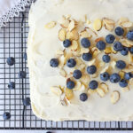 overhead shot of blueberry cake with almonds on top
