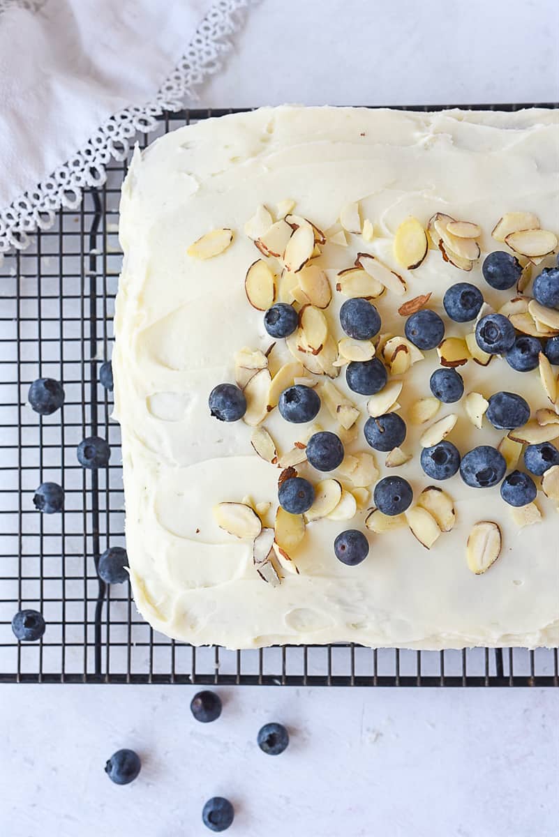 overhead shot of blueberry cake with almonds on top