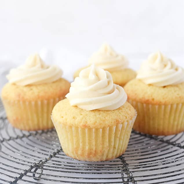 four cupcakes with frosting