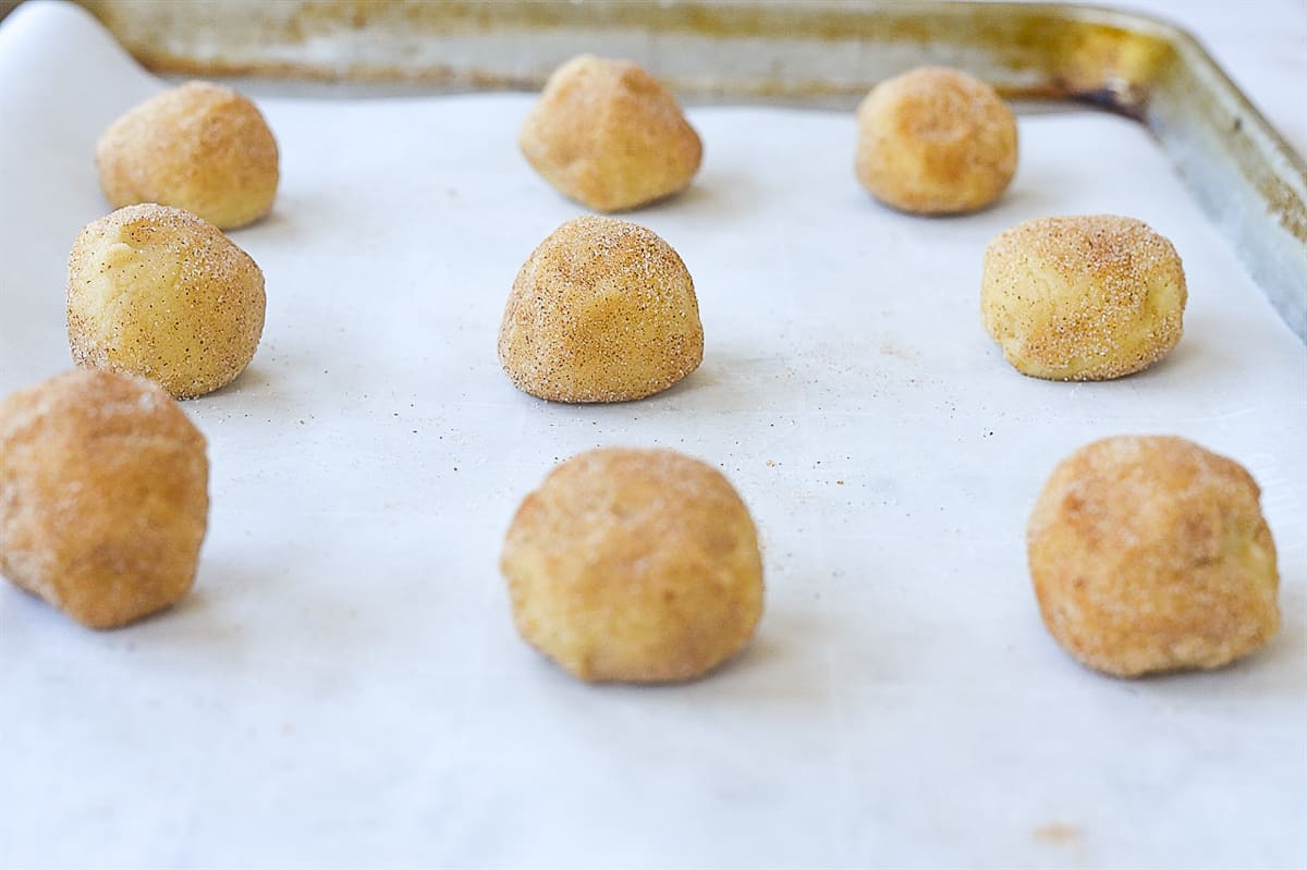 snickerdoodle cookie dough balls on baking sheet