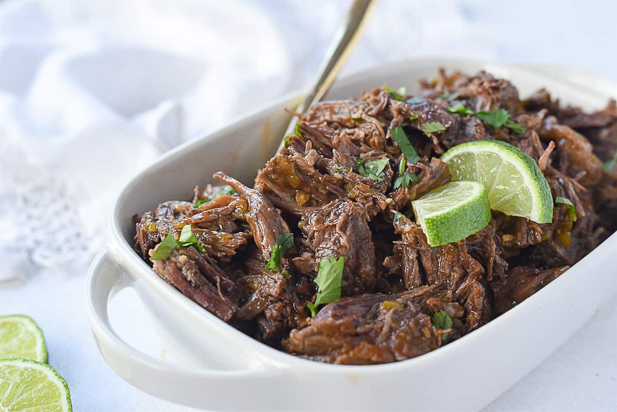 beef barbacoa with cilantro and lime on top