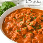 white bowl of butter chicken with cilantro on top