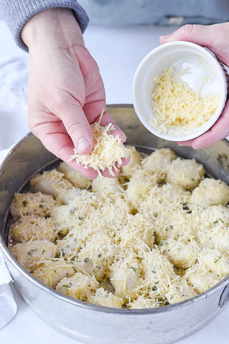 sprinkling cheese over dough