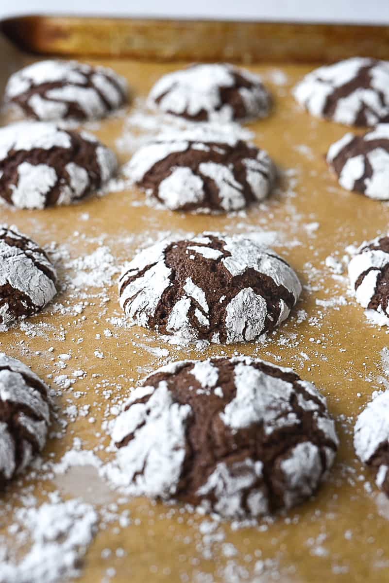 baked chocolate crinkle cookies on a baking sheet