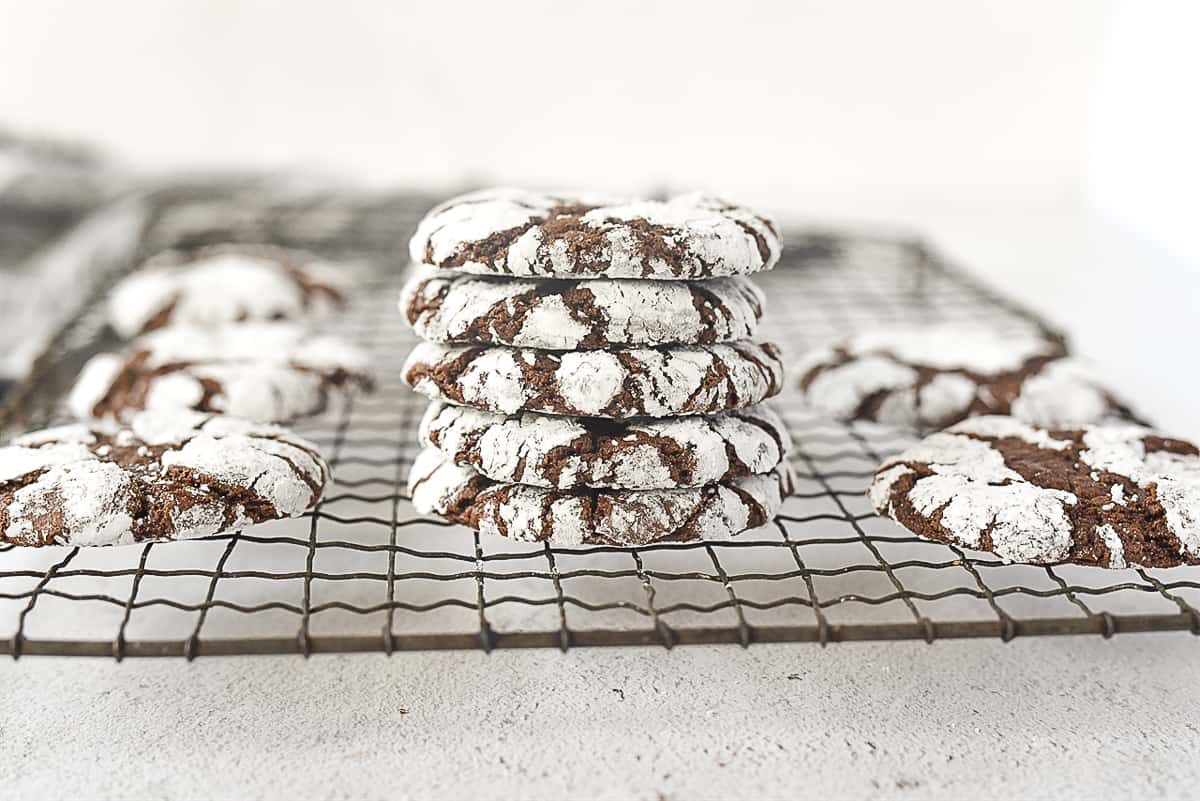 stack of chocolate crinkle cookies on a rack