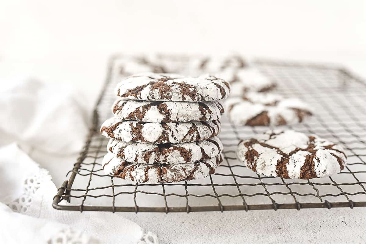 stack of chocolate crinkle cookies on a cooling rack