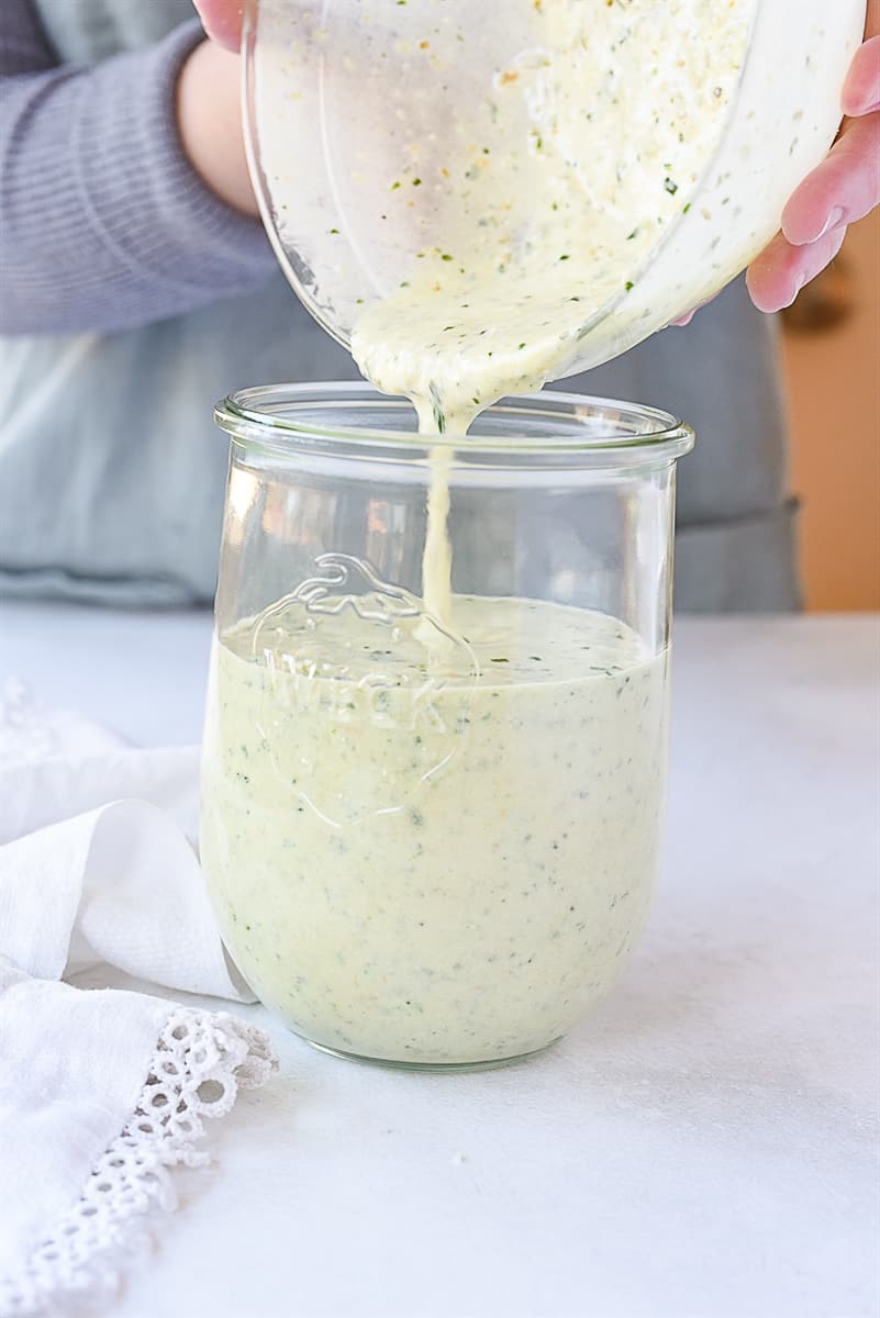 pouring dressing into jar