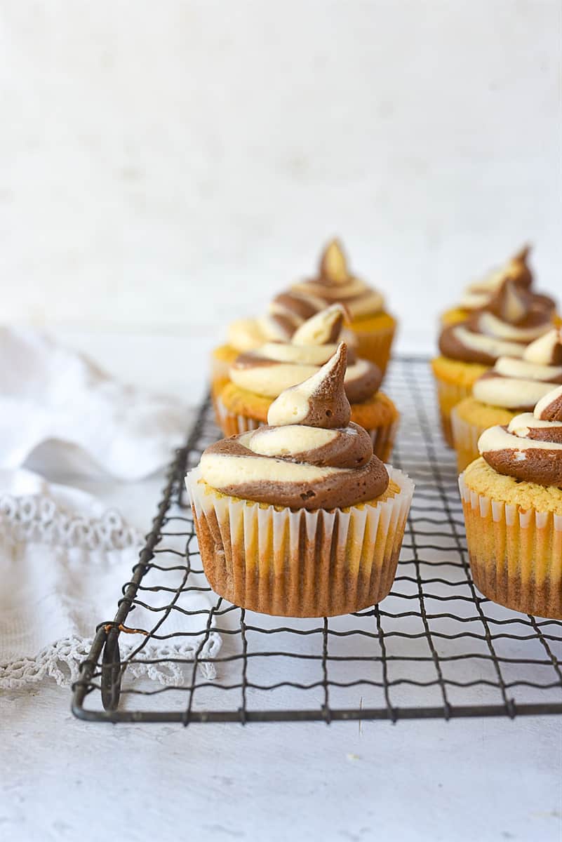 peanut butter chocolate cupcakes on a cooling rack