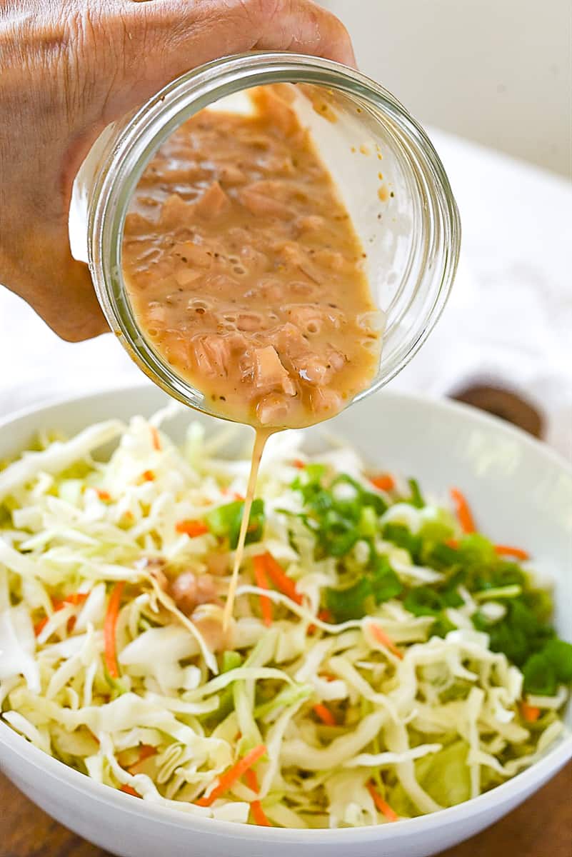 pouring dressing on coleslaw