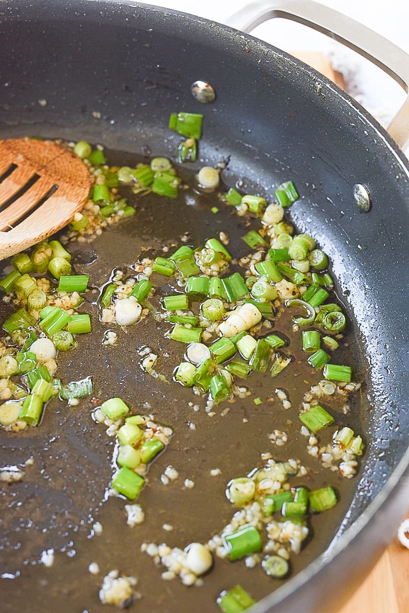 cooking green onions in pan