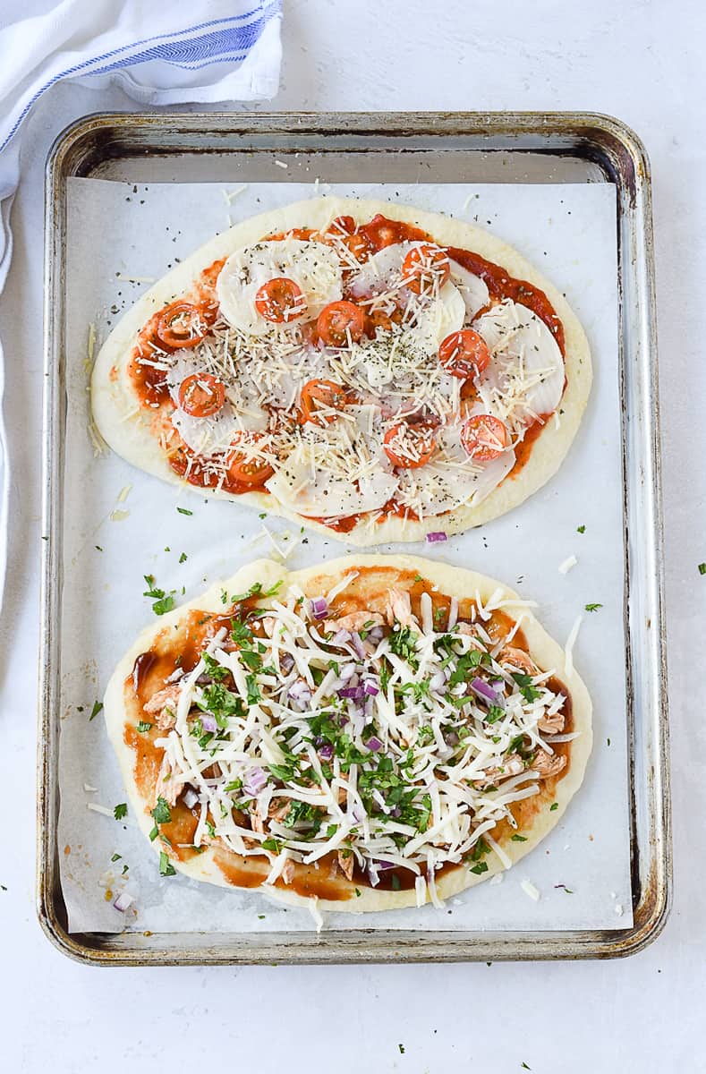 overhead of flatbread with pizza toppings.