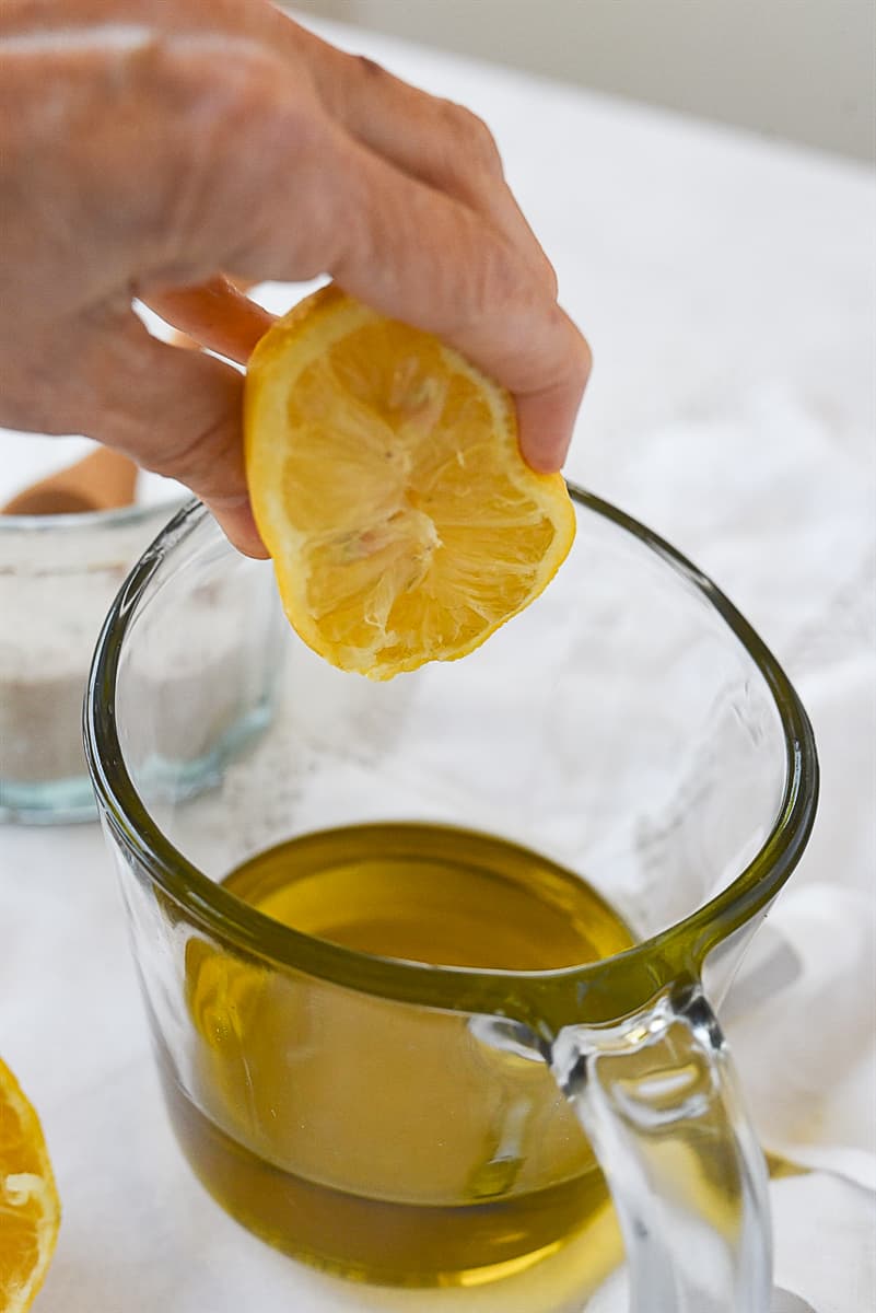 squeezing lemon into dressing