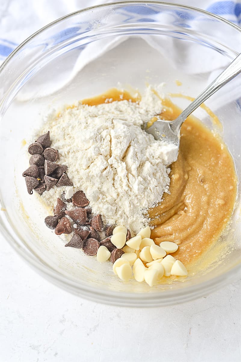 adding flour into cookie dough