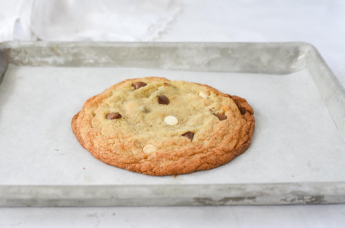 baked chocolate chip cookie on cookie sheet