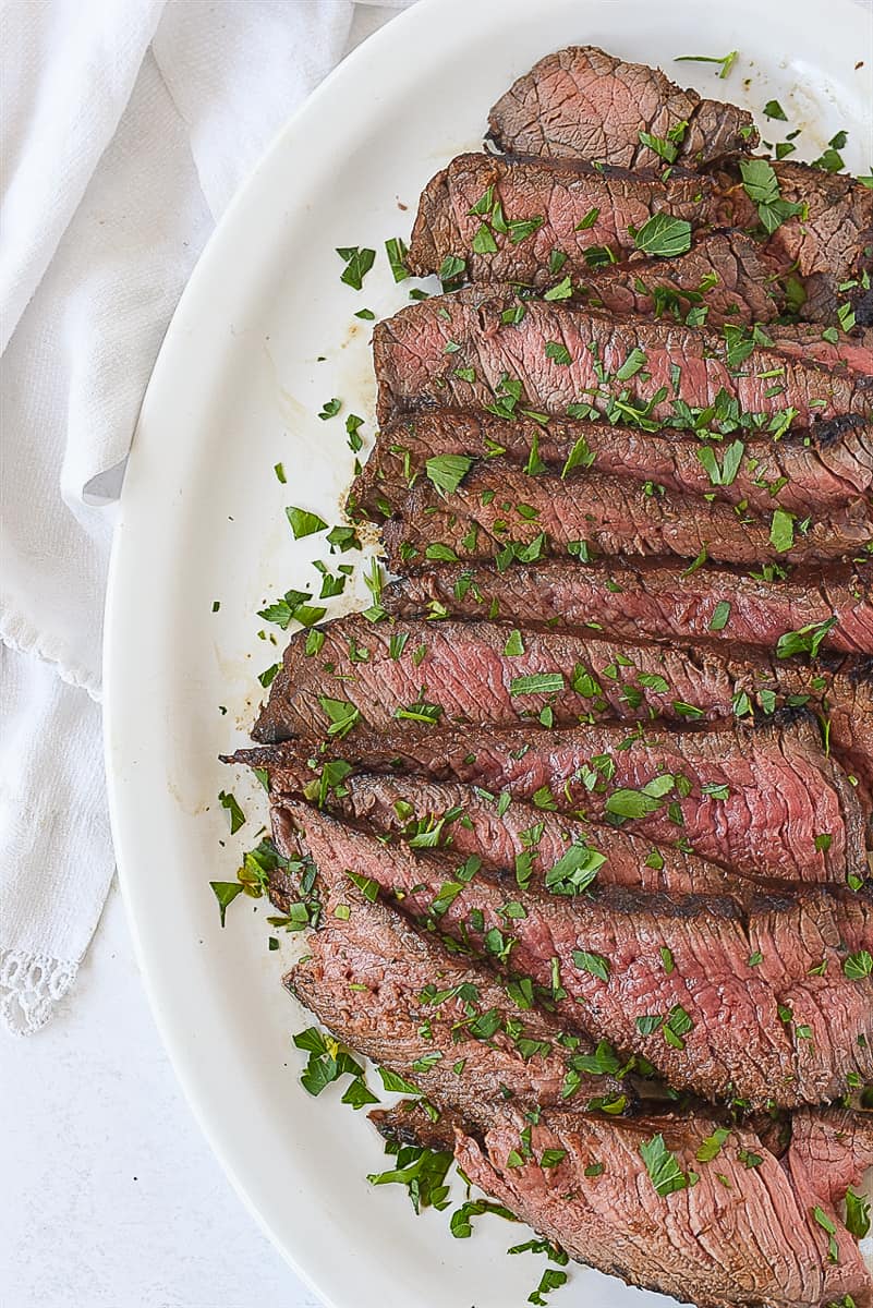 sliced london broil with parlsey on top