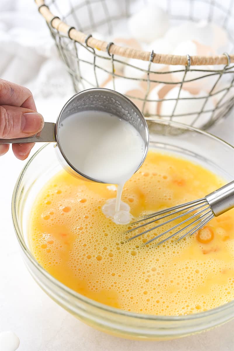 adding milk to eggs