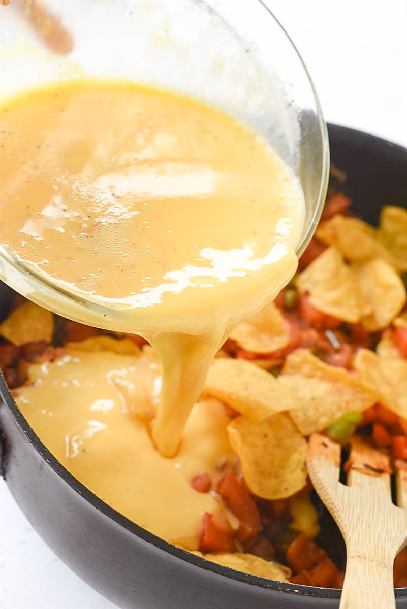 pouring eggs into migas pan