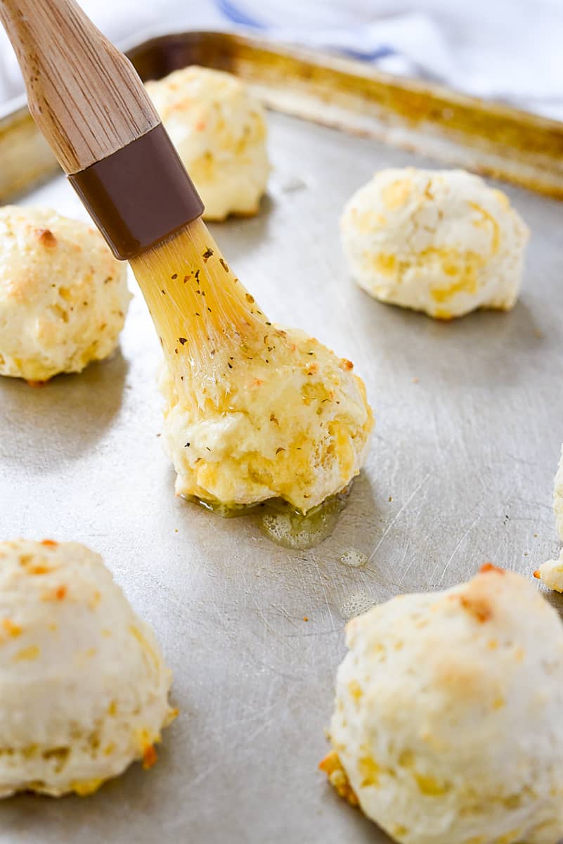 brushing biscuits with butter