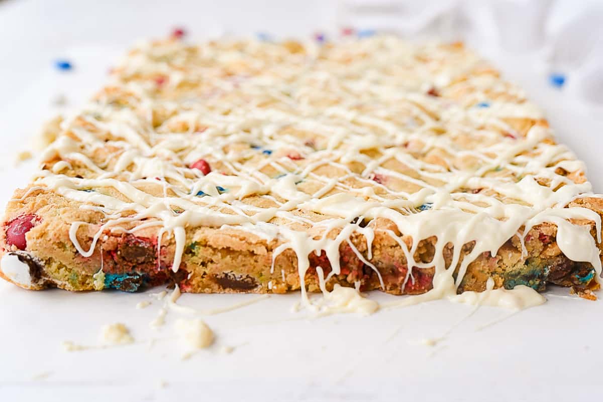 M &M Blondies drizzled with chocolate