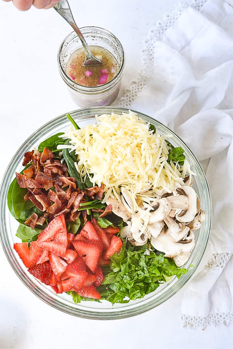 spinach salad ingredients in a bowl