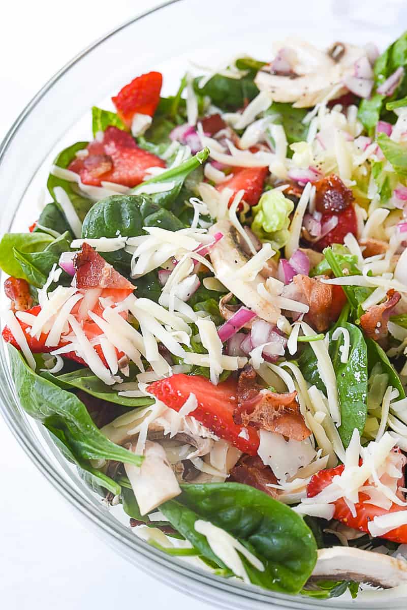 closeup shot of spinach salad in a bowl