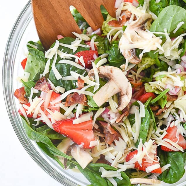 overhead shot of spinach salad in a bowl