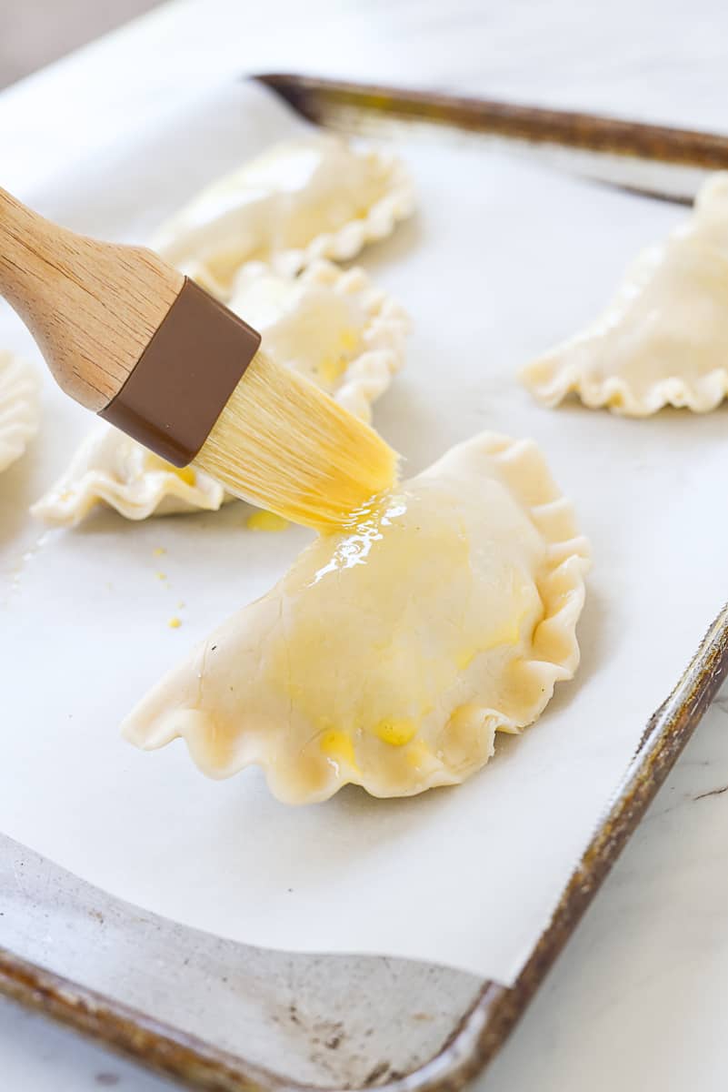 brushing egg on cornish pastry