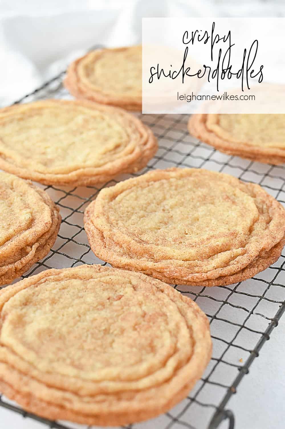 crispy snickerdoodle cookies on a cooling rack