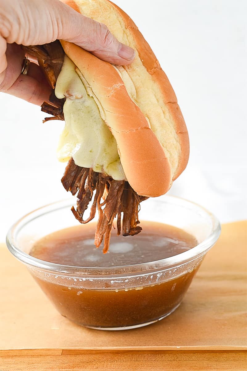 dipping tri tip sandwich in au jus