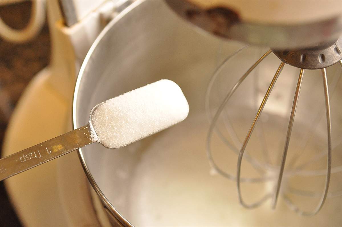 pouring sugar into egg whites